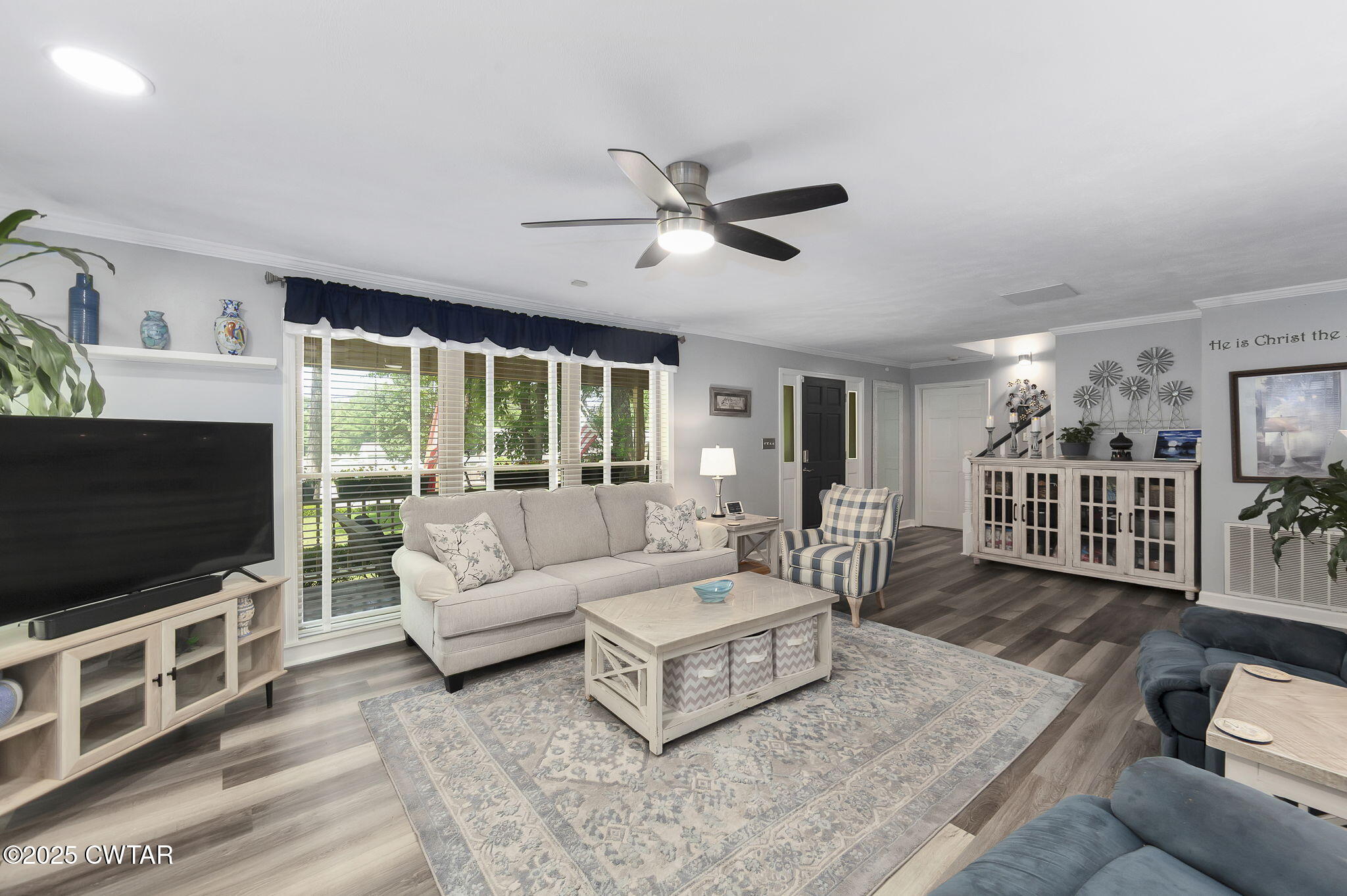 160 Plantation Road Jackson, TN 38305 - Photo 5 of 50 a living room with furniture a flat screen tv and a floor to ceiling window