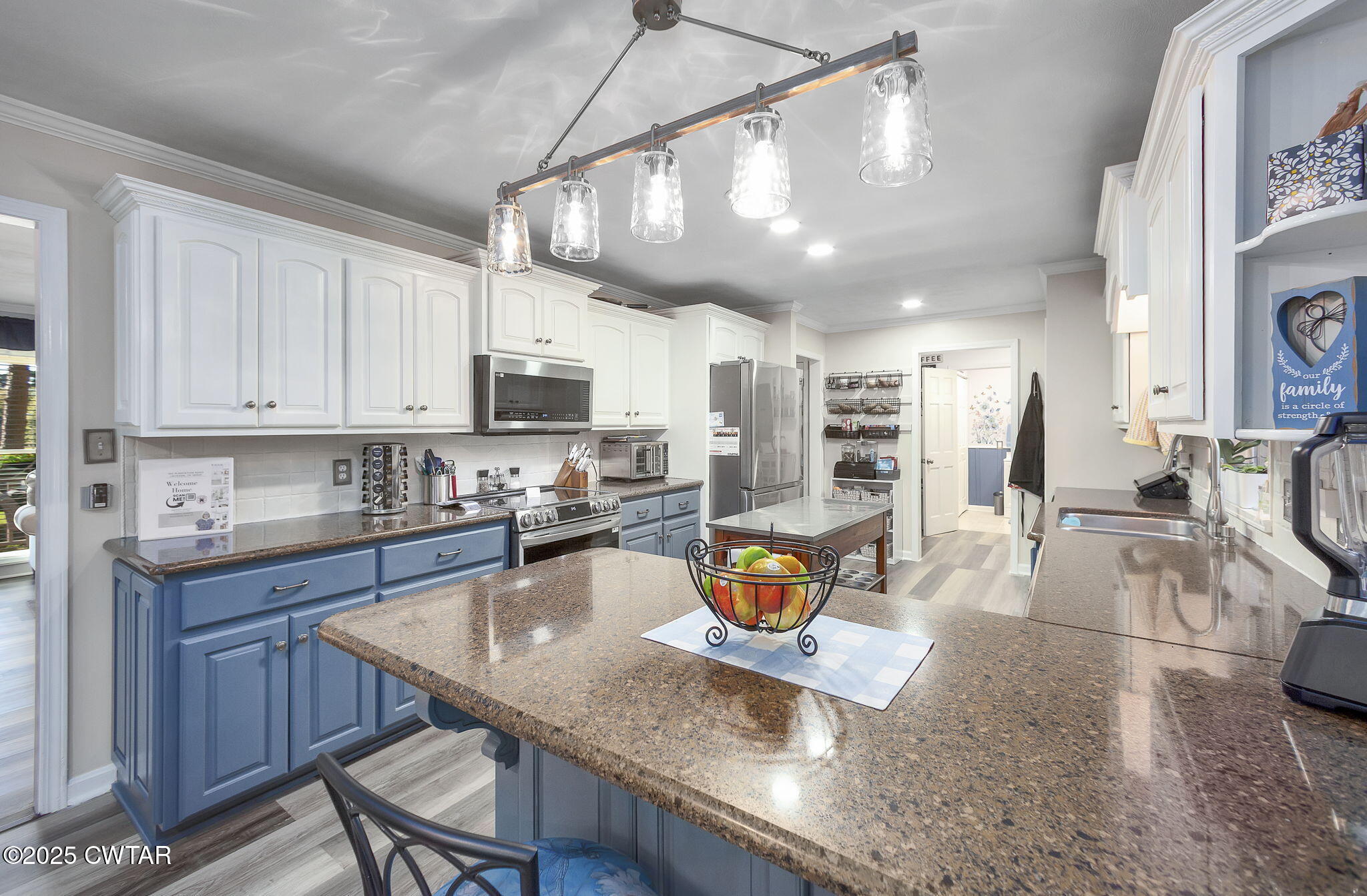 160 Plantation Road Jackson, TN 38305 - Photo 9 of 50 a kitchen with stainless steel appliances granite countertop a sink a stove and a wooden cabinets