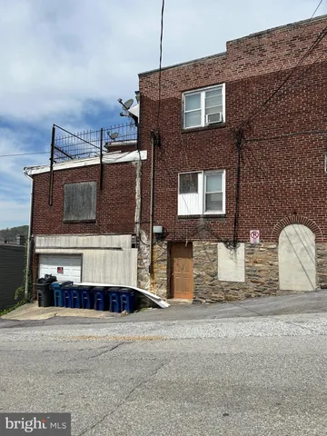 a front view of a house with a road