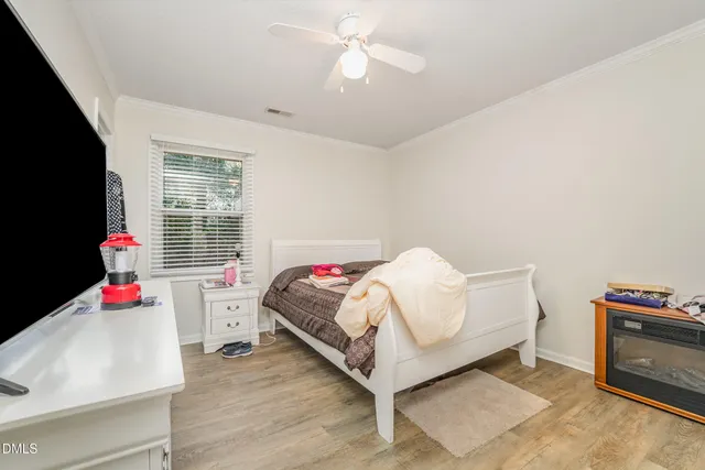 a bedroom with furniture and a flat screen tv