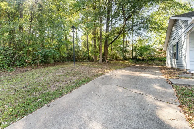 a view of a street with trees in front of it