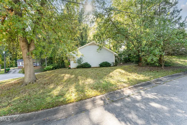 a view of a backyard with large trees