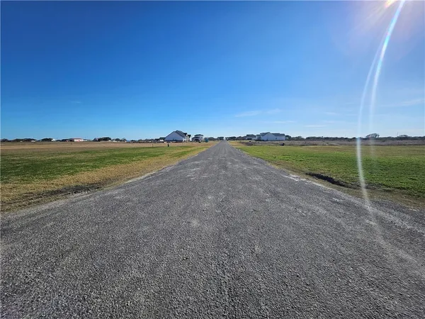 a view of a field with an ocean