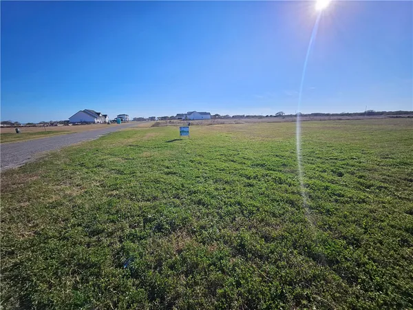 a view of a green field with clear sky