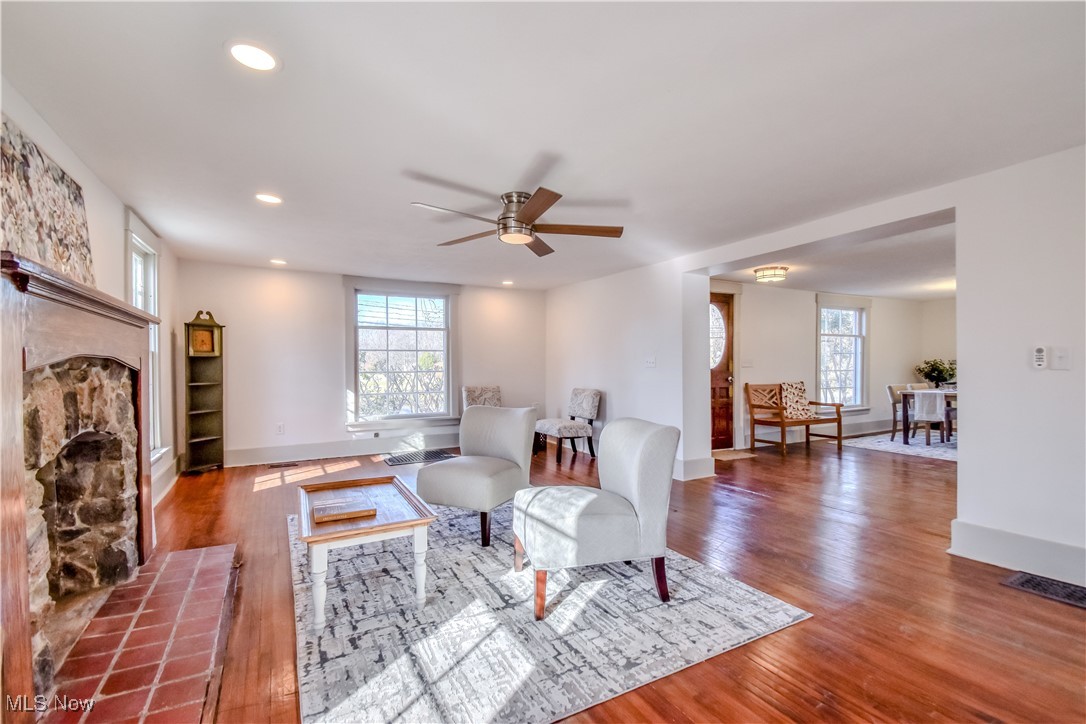 6416 Chapel Road Madison, OH 44057 - Photo 18 of 35 Living area featuring ceiling fan, plenty of natural light, wood finished floors, and a tile fireplace