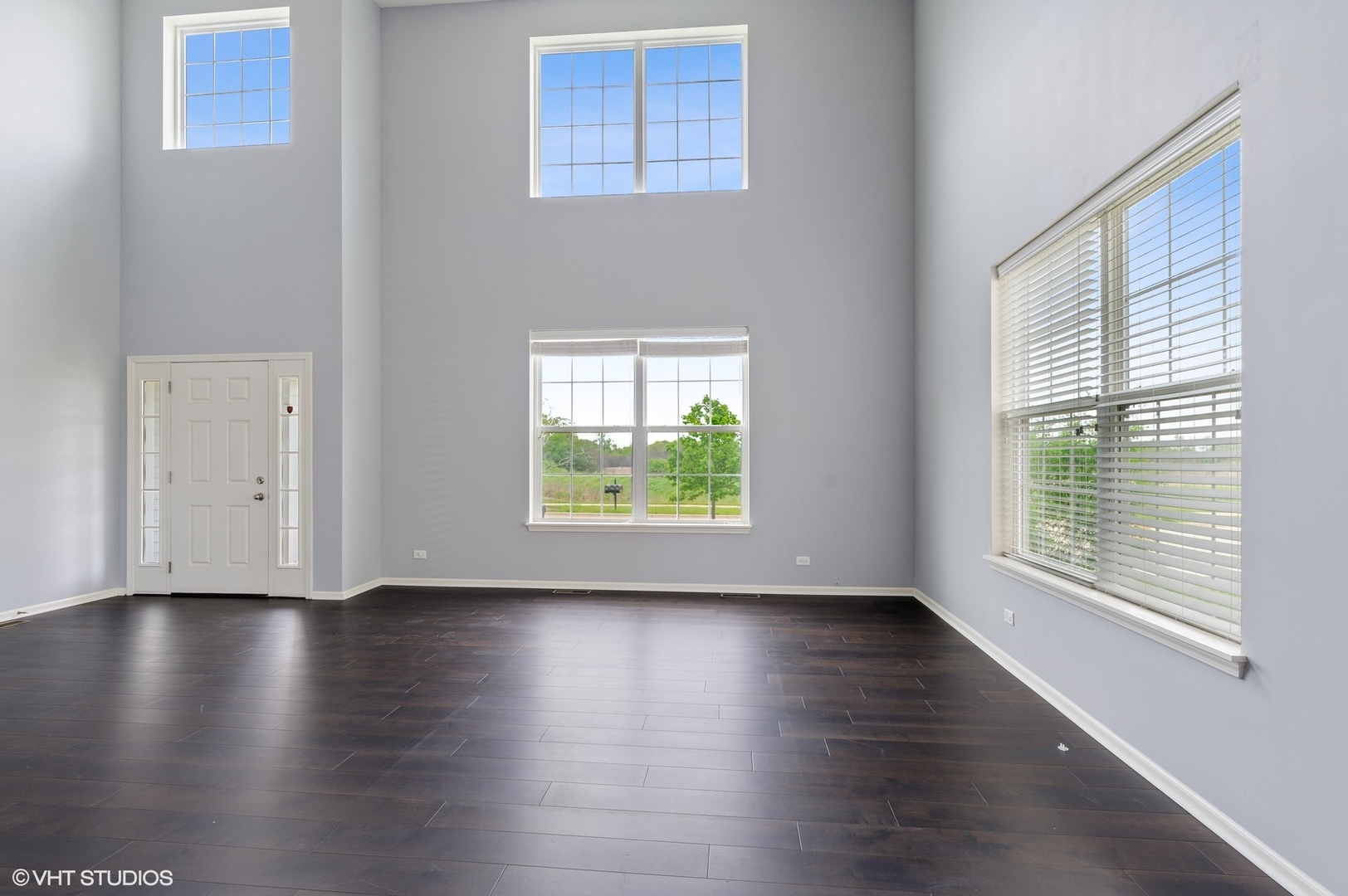 1439 Viola Lane Volo, IL 60073 - Photo 2 of 11 a view of an empty room with wooden floor and a window