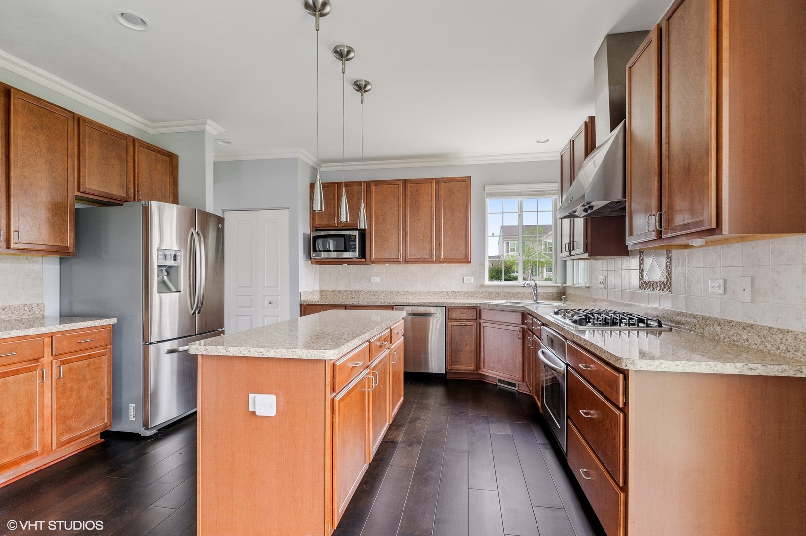 1439 Viola Lane Volo, IL 60073 - Photo 3 of 11 a kitchen with stainless steel appliances granite countertop a stove top oven a refrigerator a sink and dishwasher with wooden floor