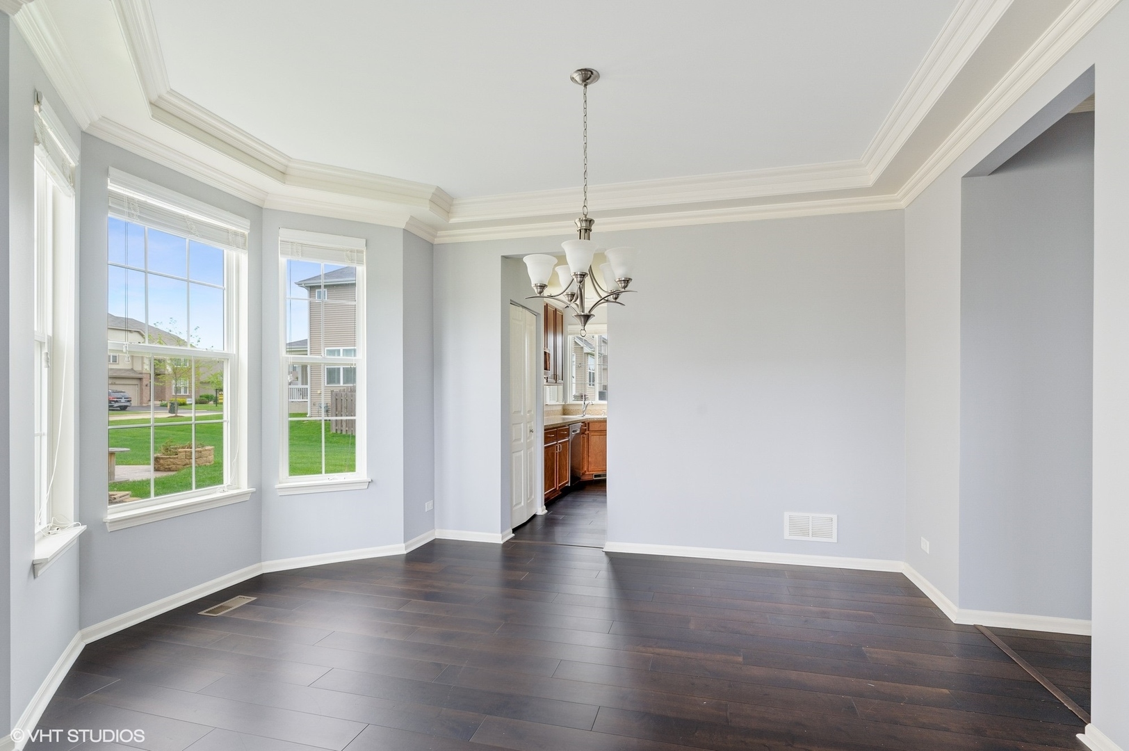 1439 Viola Lane Volo, IL 60073 - Photo 4 of 11 a view of a room with wooden floor chandelier and windows