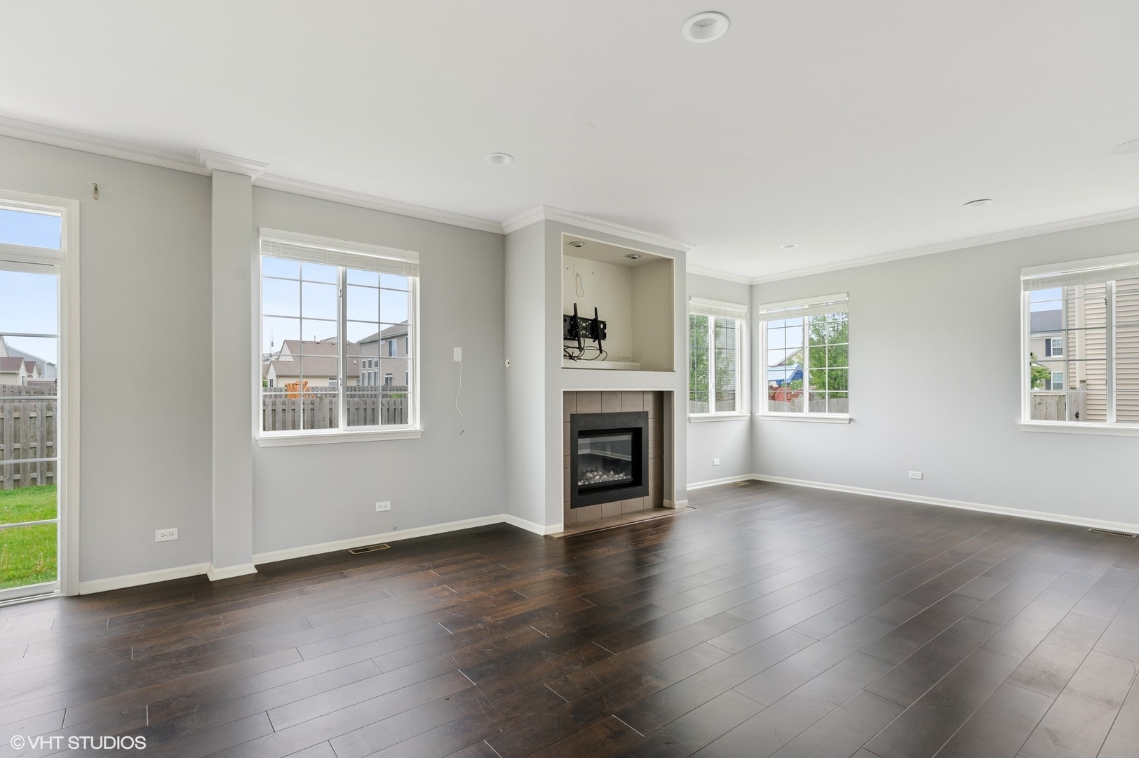 1439 Viola Lane Volo, IL 60073 - Photo 5 of 11 an empty room with wooden floor fireplace and windows