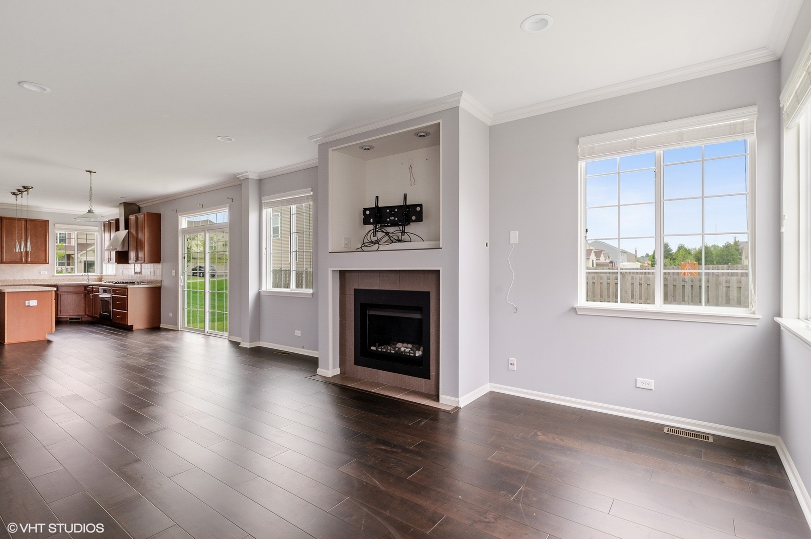 1439 Viola Lane Volo, IL 60073 - Photo 6 of 11 wooden floor fireplace and windows in an empty room
