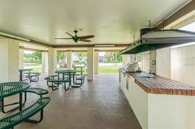 a living room with furniture a flat screen tv and kitchen view
