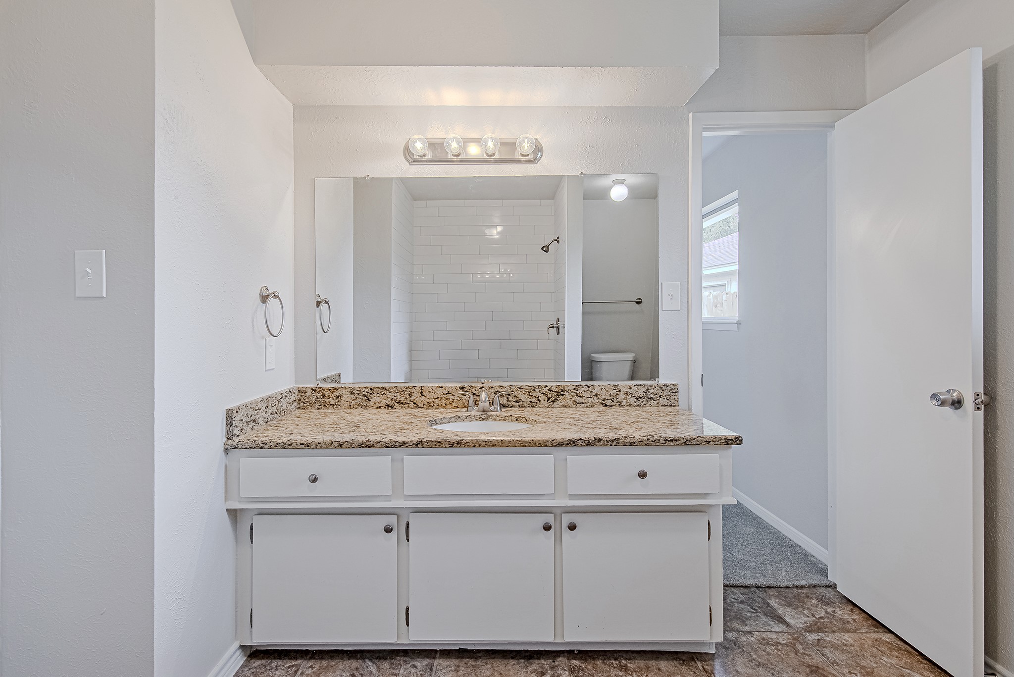 24306 Spring Mill Lane Spring, TX 77373 - Photo 4 of 24 a bathroom with a granite countertop sink and a mirror