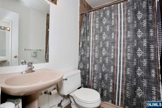 290 Hamilton Place, Unit 4 Hackensack, NJ 07601 - Photo 32 of 50 a bathroom with a sink toilet and shower