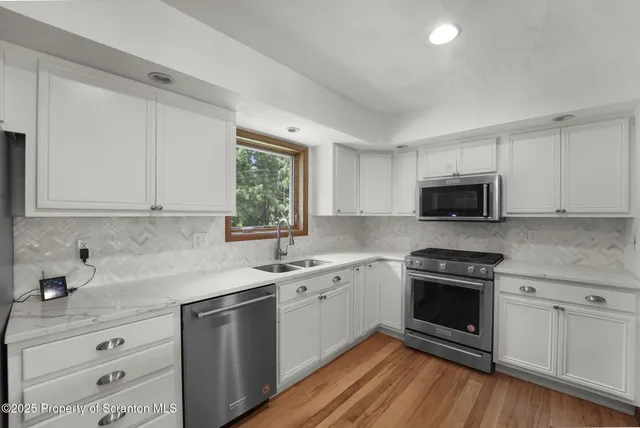 a kitchen with refrigerator and microwave