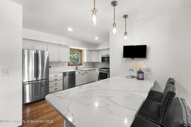 a kitchen with appliances cabinets and a sink
