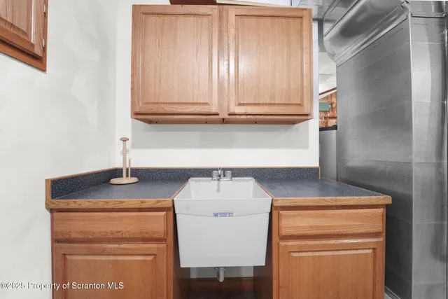 a view of kitchen with sink and cabinets