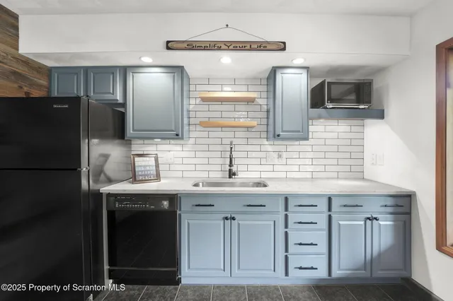 a large kitchen with cabinets and a window