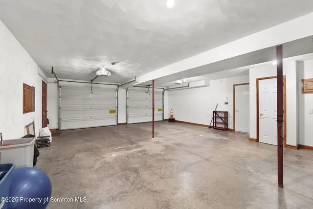 a front view of a house with a yard and potted plants