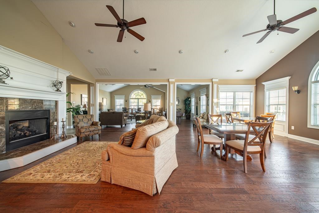 8848 Promenade Place Columbus, GA 31820 - Photo 20 of 21 a living room with furniture a fireplace and a ceiling fan