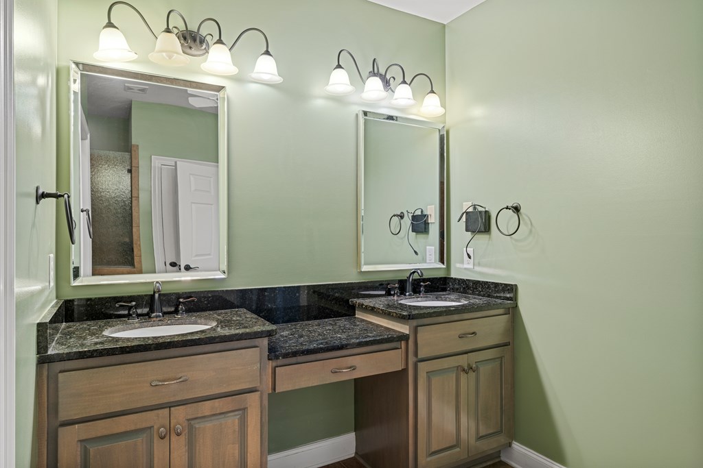 8848 Promenade Place Columbus, GA 31820 - Photo 9 of 21 a bathroom with a granite countertop sink and a mirror