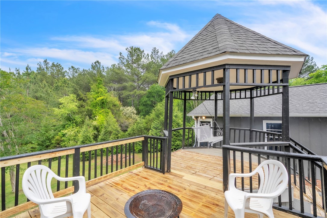 722 Lay Bridge Road Central, SC 29630 - Photo 26 of 32 Enjoy outdoor living on this expansive deck, complete with a charming gazebo and lush surroundings.