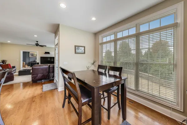 a view of a livingroom with wooden floor and a window