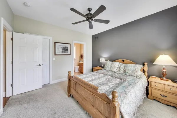a bedroom with a bed and ceiling fan
