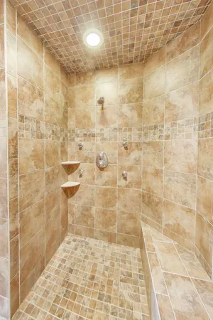 a bathroom with a granite countertop sink a toilet and a mirror