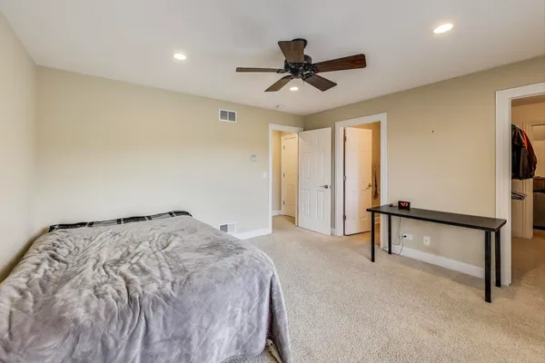 a view of empty room with cabinet and ceiling fan