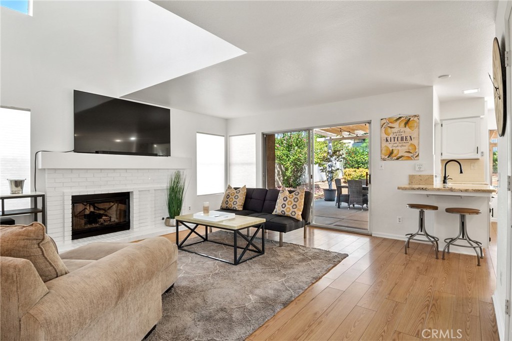 9376 Ruby Red Court Riverside, CA 92508 - Photo 16 of 54 a living room with furniture a fireplace and a flat screen tv