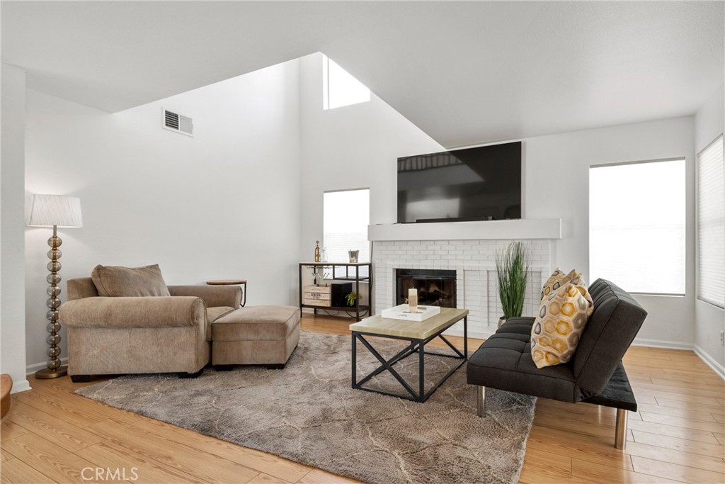 9376 Ruby Red Court Riverside, CA 92508 - Photo 17 of 54 a living room with furniture a flat screen tv and a fireplace