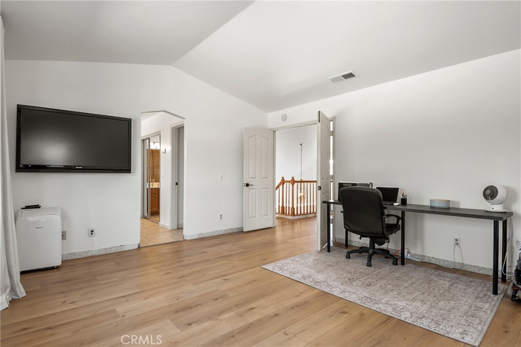 9376 Ruby Red Court Riverside, CA 92508 - Photo 22 of 54 a view of a workspace with furniture and wooden floor