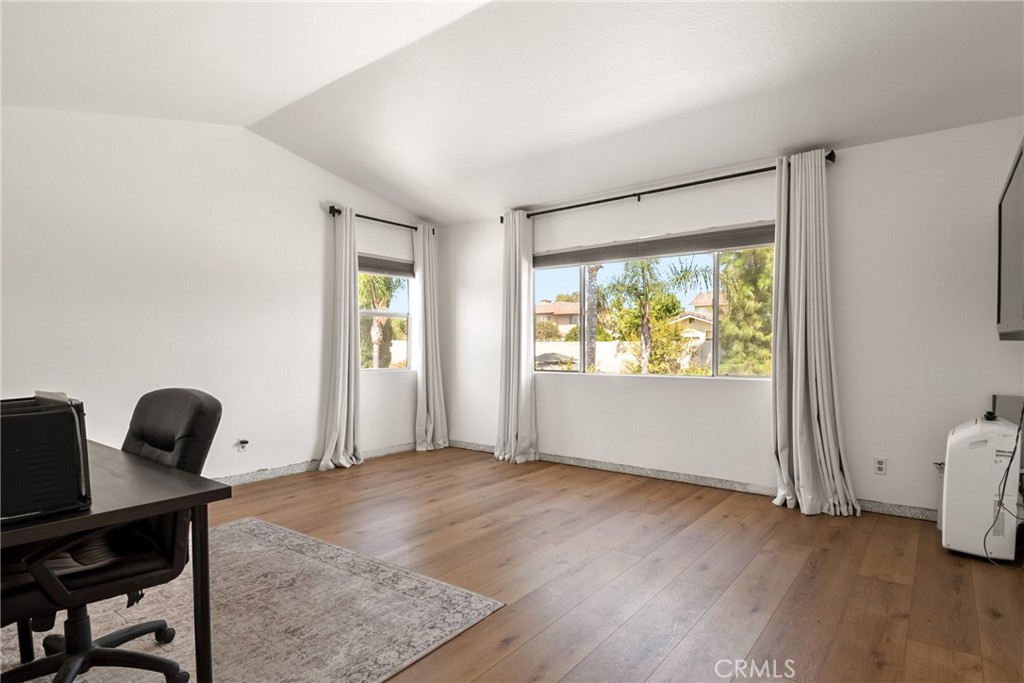 9376 Ruby Red Court Riverside, CA 92508 - Photo 24 of 54 a view of an empty room with a window and wooden floor