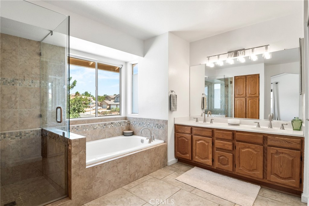 9376 Ruby Red Court Riverside, CA 92508 - Photo 25 of 54 a spacious bathroom with a tub sink shower and mirror