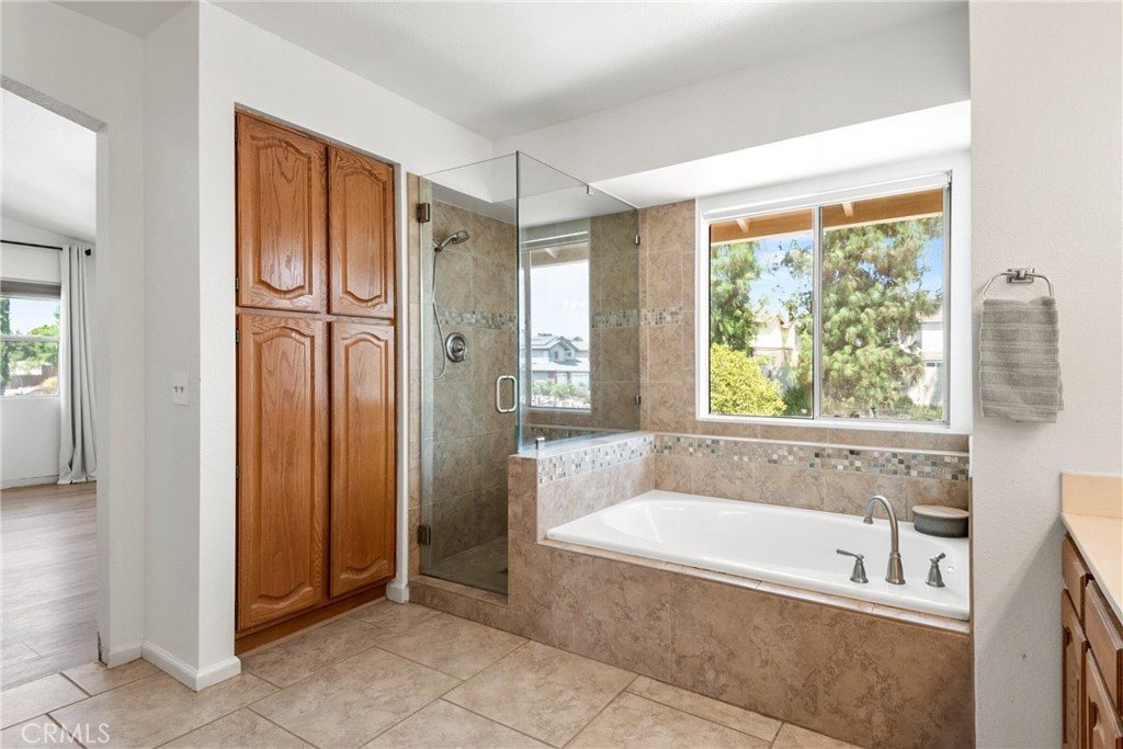 9376 Ruby Red Court Riverside, CA 92508 - Photo 26 of 54 a spacious bathroom with a tub shower and window