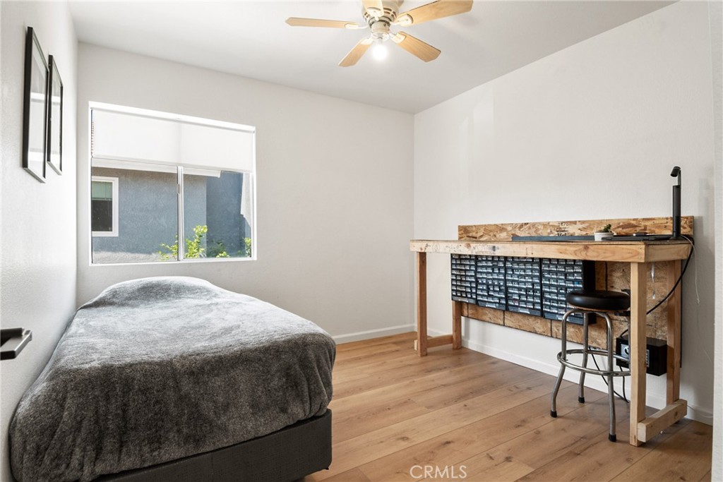 9376 Ruby Red Court Riverside, CA 92508 - Photo 28 of 54 a bedroom with a bed and a table with chair