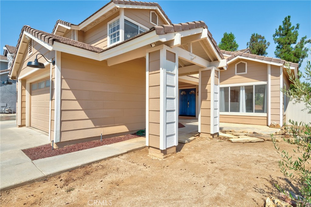 9376 Ruby Red Court Riverside, CA 92508 - Photo 3 of 54 a front view of a house with a yard