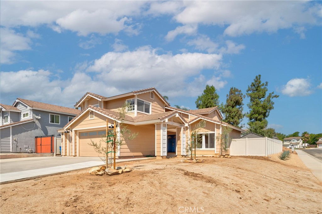 9376 Ruby Red Court Riverside, CA 92508 - Photo 34 of 54 a front view of a house with a yard and garage
