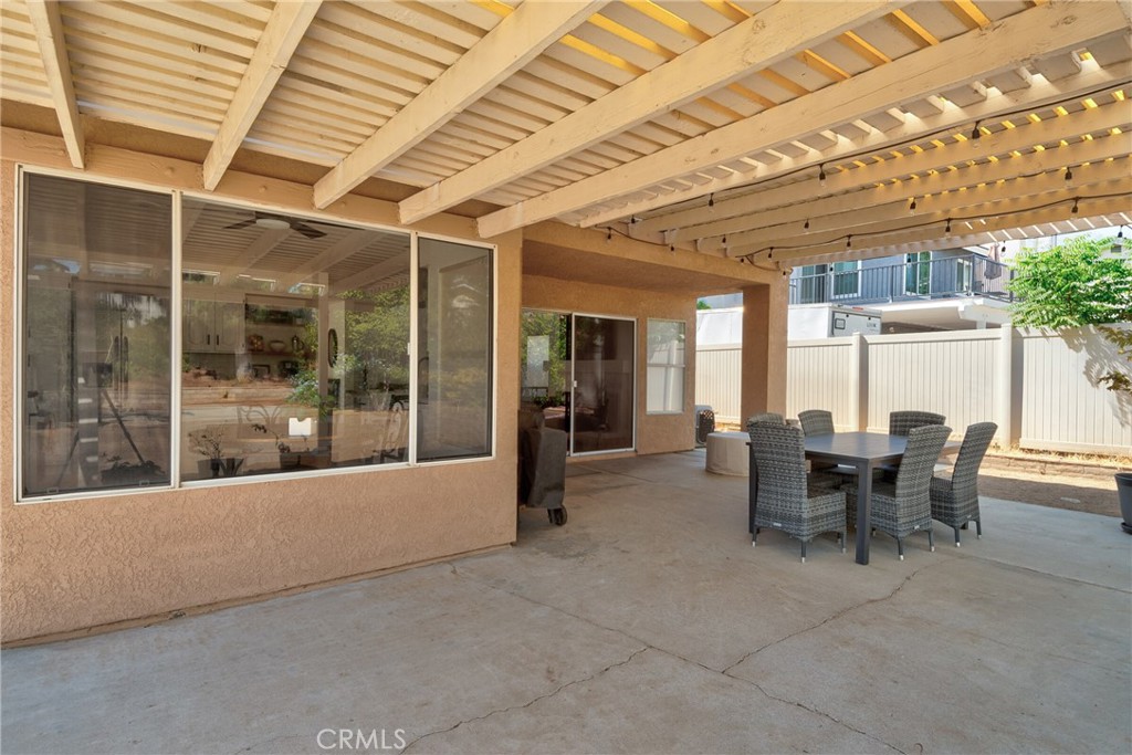 9376 Ruby Red Court Riverside, CA 92508 - Photo 42 of 54 a view of a dining room with furniture and floor to ceiling window