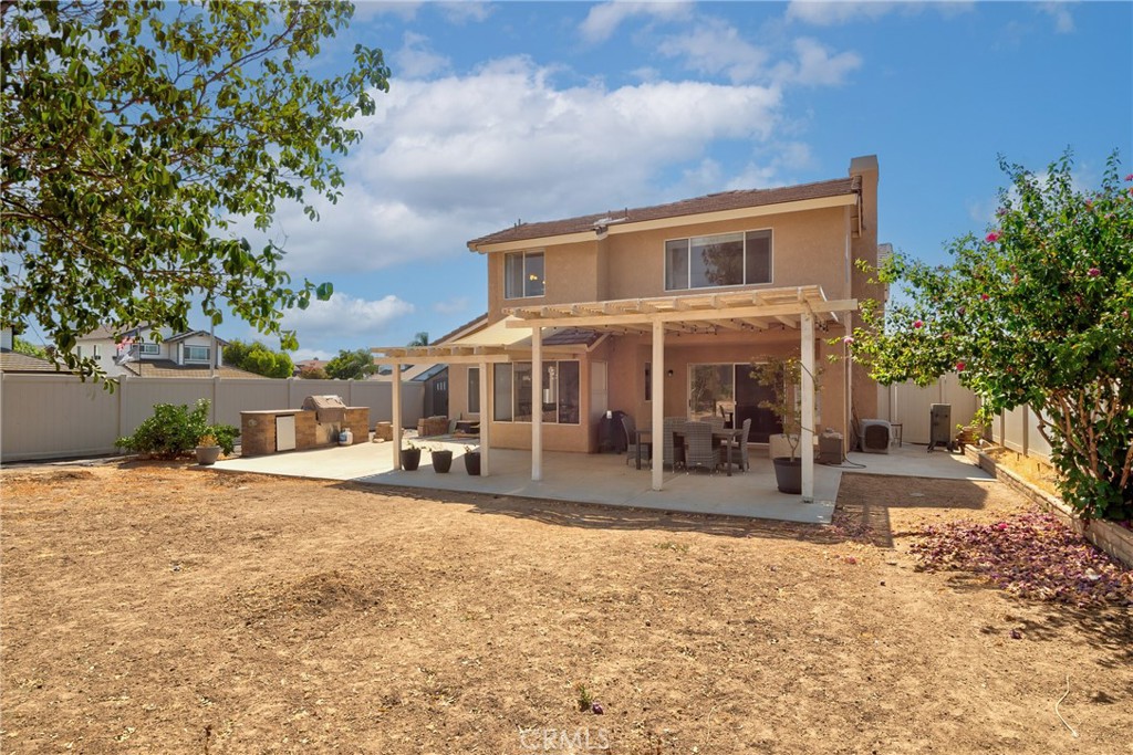 9376 Ruby Red Court Riverside, CA 92508 - Photo 46 of 54 a front view of a house with a yard and lake view