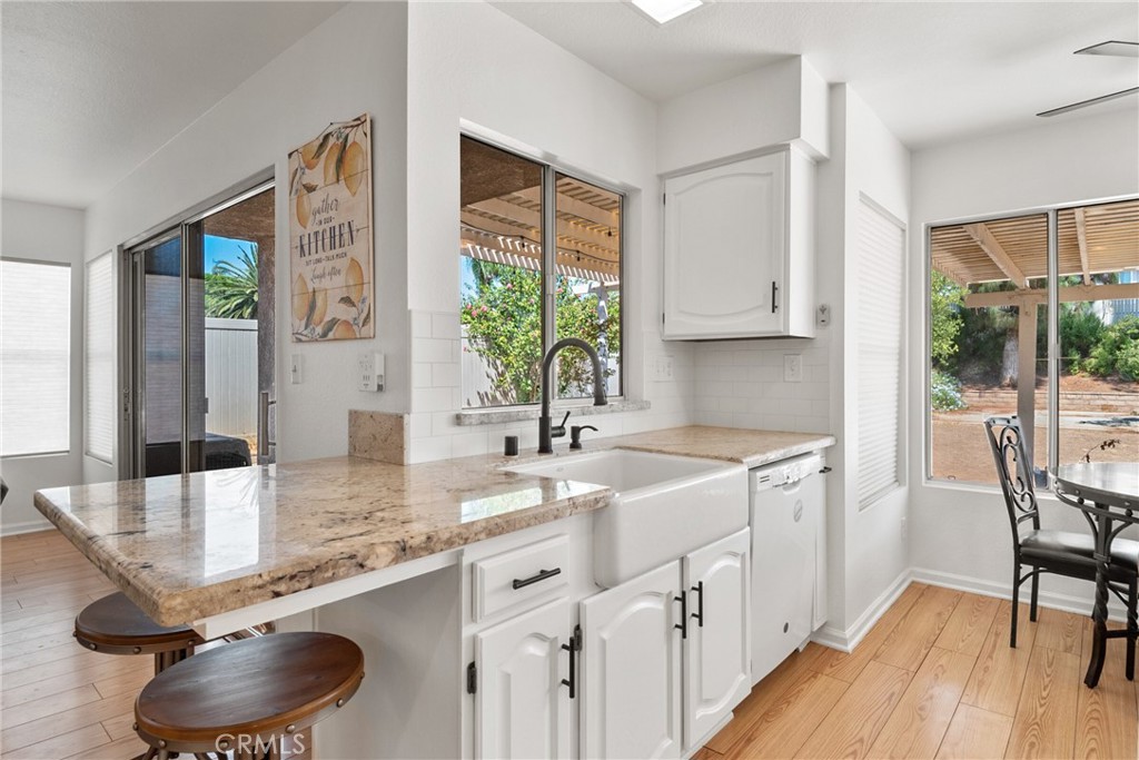 9376 Ruby Red Court Riverside, CA 92508 - Photo 7 of 54 a kitchen with stainless steel appliances granite countertop a sink a stove and a wooden cabinets