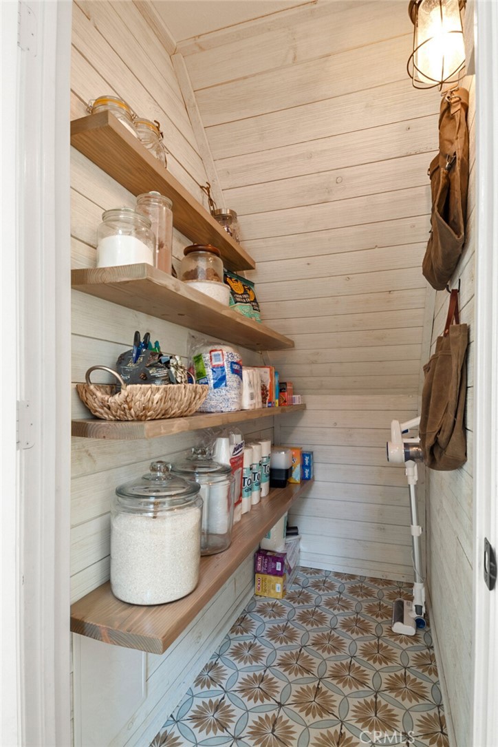 9376 Ruby Red Court Riverside, CA 92508 - Photo 10 of 54 a room with water heater and storage racks