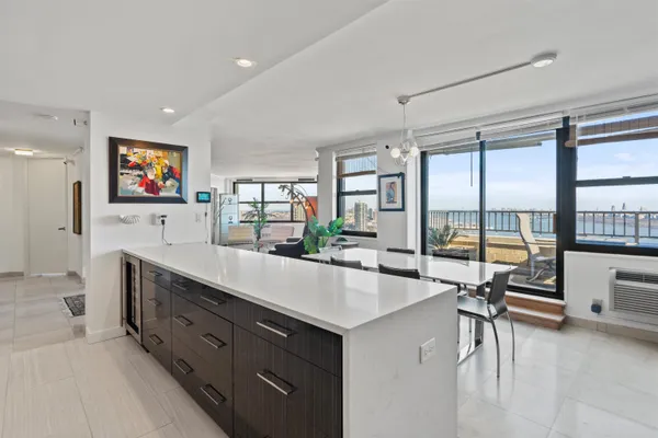 a large white kitchen with a large window