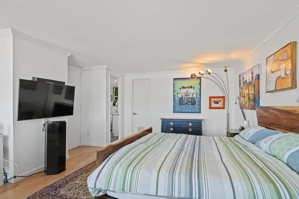 a bedroom with a bed and a flat screen tv