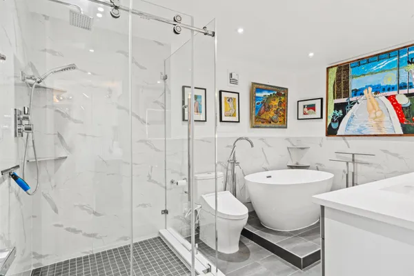 a white toilet sitting next to a bathroom sink