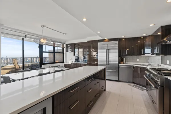 a large kitchen with stainless steel appliances a lot of counter space and a sink