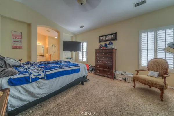 a large bathroom with a tub a sink and a large mirror