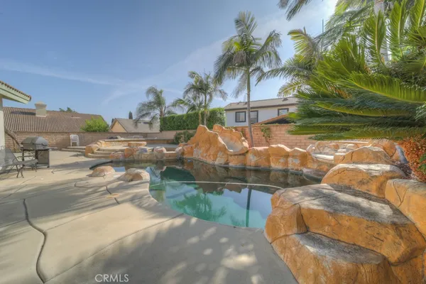 a backyard of a house with table and chairs