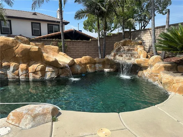 a backyard of a house with table and chairs