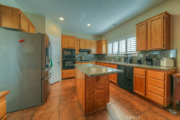 a large kitchen with a table and chairs